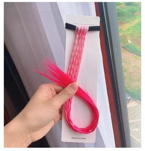 Detailed close-up of light pink to rose red gradient hair extension braids on a card