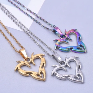 Detailed view of heart-shaped pendants in gold, silver, and rainbow plating finishes