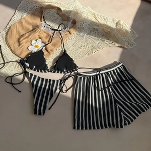 Detailed view of black and white striped bikini set with matching tie-waist shorts