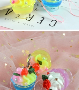 Detailed view of mini artificial dessert charms featuring resin cream and fruit berries