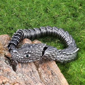 Stereoscopic stainless steel snake chain bracelet with green gemstone eyes in silver finish
