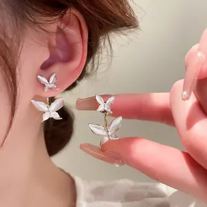 Elegant gold butterfly stud earrings with white enamel double-layer design for women