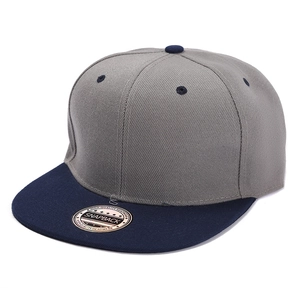 Detail view of grey and navy snapback cap with flat brim and twill cotton texture