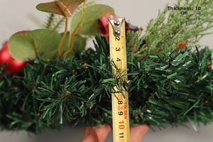 Detail shot showing a 10cm thickness measurement of a Christmas eucalyptus wreath
