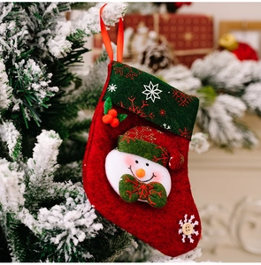 Detail of Christmas stocking featuring 3D snowman and snowflake embroidery on tree branch