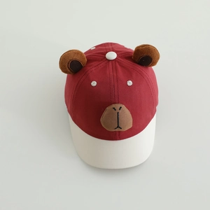 Detail of red and cream kids baseball cap with plush animal ears and face embroidery