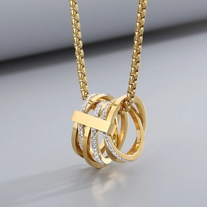 Macro view of gold multi-layered linked ring pendant with cubic zirconia inlay details
