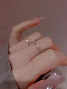 Close-up of elegant gold and rose gold frosted stainless steel rings on a hand