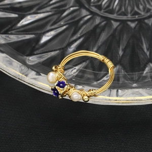 Vintage gold wire-wrapped ring featuring natural white pearls and a blue flower design