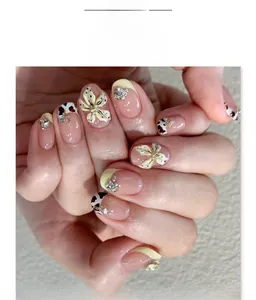 Detail of 3D white floral nail art with leopard print and sparkling rhinestones