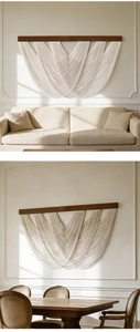 Detail of Nordic wall hanging with solid wood beams and cream cotton tassel layers