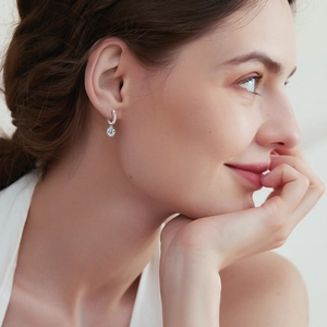 Elegant S925 silver hoop earrings with D color moissanite on a female model