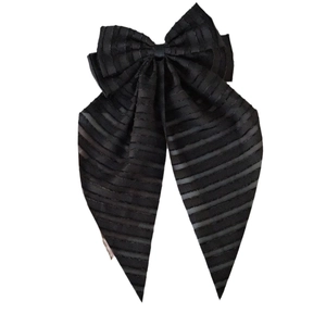 Elegant black striped bow hair clip with long mesh ribbon for women in white background