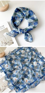 Detailed view of floral blue cotton linen scarf with soft texture and artistic print
