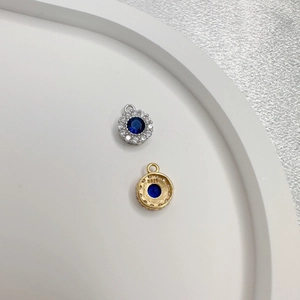 Close-up of S925 sterling silver oval pendants with blue stone and halo crystals