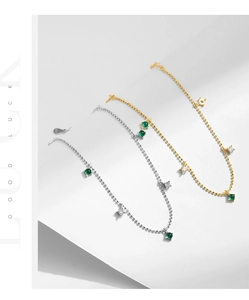 Detail of s925 silver beaded chain bracelet featuring green emerald and square zircon charms
