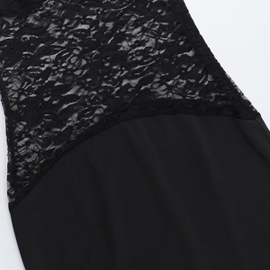 Close-up of intricate black lace stitching and premium smooth fabric on the party dress