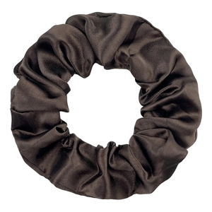 Detail of soft silk-like satin scrunchie texture in deep chocolate brown fabric