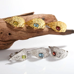 Leaf design open rings in gold and silver set with colorful garnet and topaz stones