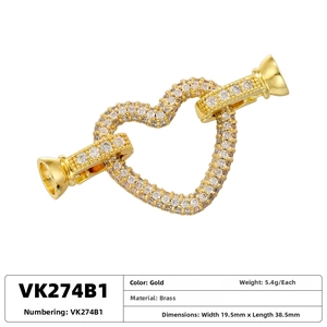 Macro detail of gold plated brass heart connector with white cubic zirconia micro-pave