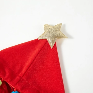 Close-up of red velvet Christmas hat featuring a golden glitter star and textured fabric