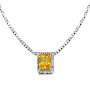 Macro shot of yellow rectangular zircon necklace with silver halo setting and tennis chain
