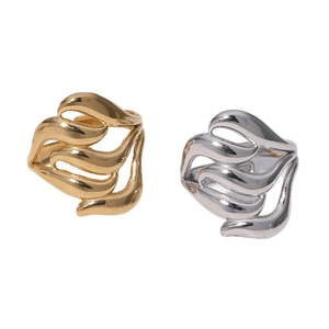 Modern hollow streamlined 18k gold and silver stainless steel rings on white background