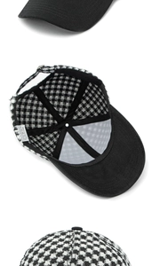 Detail of houndstooth and black baseball caps with adjustable metal back straps