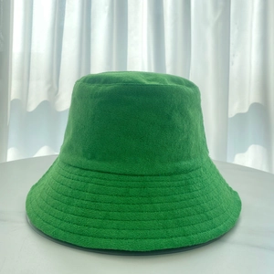 Detailed close-up of vibrant green terry cloth fabric texture on a soft bucket hat