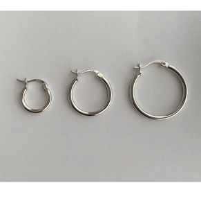 Detailed macro view of S925 sterling silver hoop earrings in three various sizes
