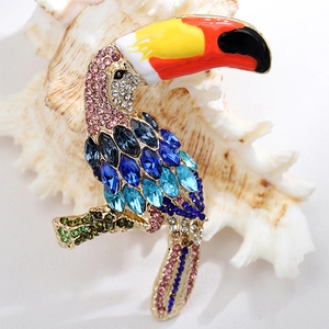 Detailed view of a colorful toucan brooch with vibrant rhinestones and golden metal finish