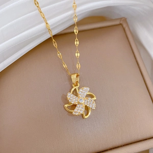 Luxury spinning windmill pendant necklace in gold with shimmering crystal inlay