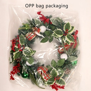 Detailed view of artificial Christmas wreath with pine cones in an OPP bag packaging