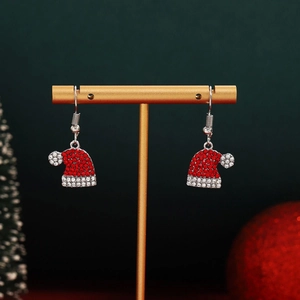 Detailed close-up of festive red and white rhinestone Santa hat earrings on a gold stand