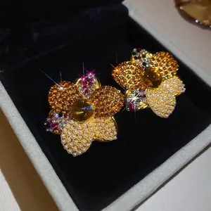 Elegant vintage court style earrings featuring faux pearls and amber crystals on golden flowers
