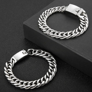 Sleek silver stainless steel Cuban link bracelet for men on a premium black background