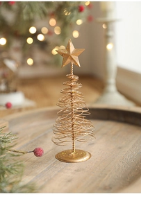Close-up of golden spiral iron Christmas tree with a sparkling star on top