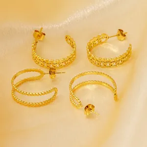 Double-layer 18K gold-plated titanium steel C-shape earrings set on champagne silk fabric
