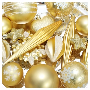 Macro shot of assorted gold Christmas ornaments with white snowflake patterns and glitter
