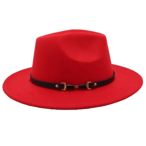 Detail of red wool fedora featuring a wide brim and black leather band with gold buckle