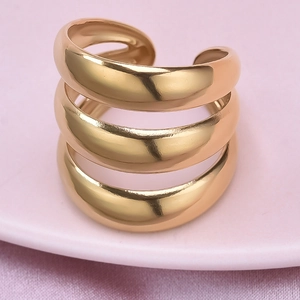 Macro shot of three-layer curved gold stainless steel open ring with polished finish