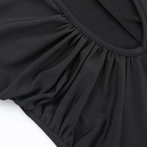 Close-up of elegant pleated details and fine sewing on the black backless dress fabric