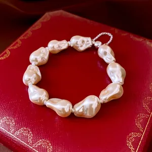 Baroque irregular pearl bracelet with silver magnetic clasp on luxury red jewelry box