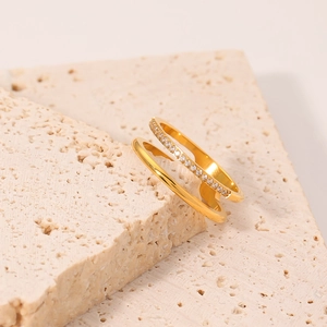 Double-layered gold stainless steel ring featuring a smooth band and pavé set crystals