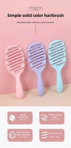 Detail view of pink and blue hollow-out vent hairbrushes with round-tip massage bristles