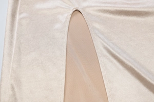 Détail de la texture velours champagne et doublure en maille chair avec couture fendue