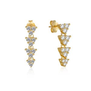 Macro shot of gold-plated silver dangle earrings with triangle drops and inlaid zircons