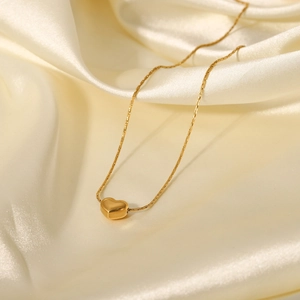Minimalist 18K gold plated stainless steel heart pendant necklace on silk fabric