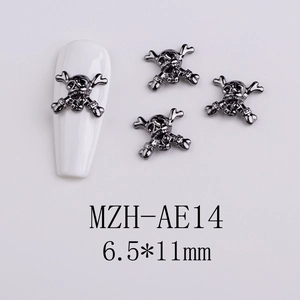 Detail view of 6.5x11mm gun-black metal skull nail charm on a white base plate