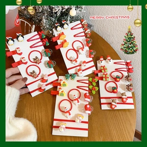 Detailed view of festive Christmas hair clips and ties with Santa and reindeer motifs